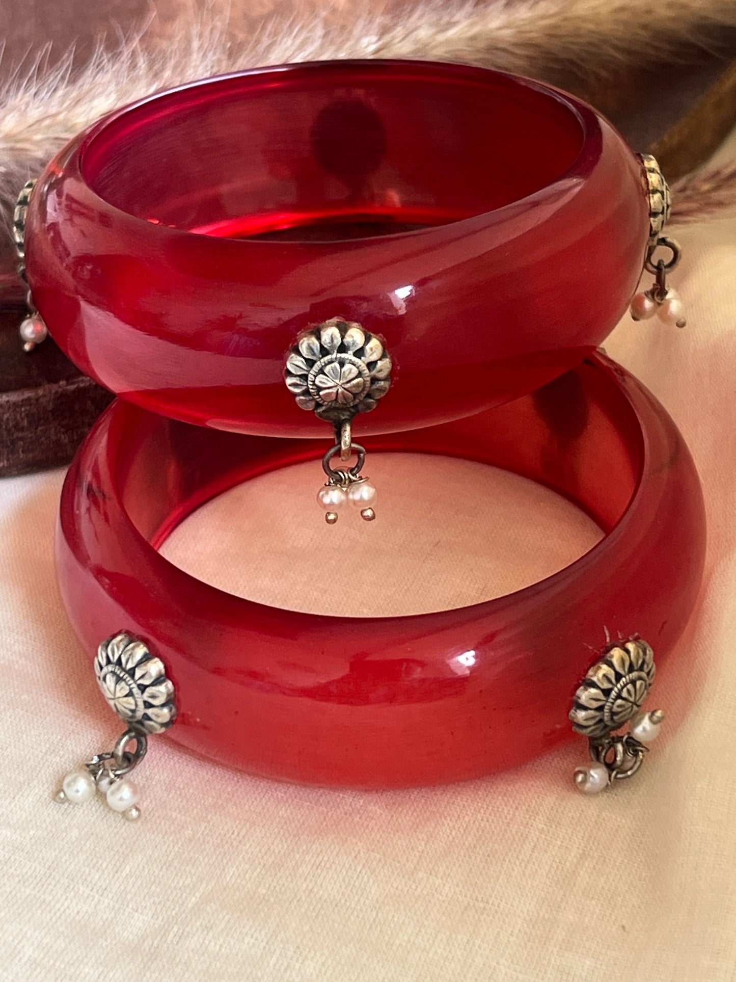 Red Resin bangles with silver motifs and pearl hangings