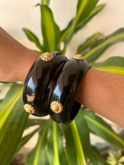 Black resin bangles with gold motifs