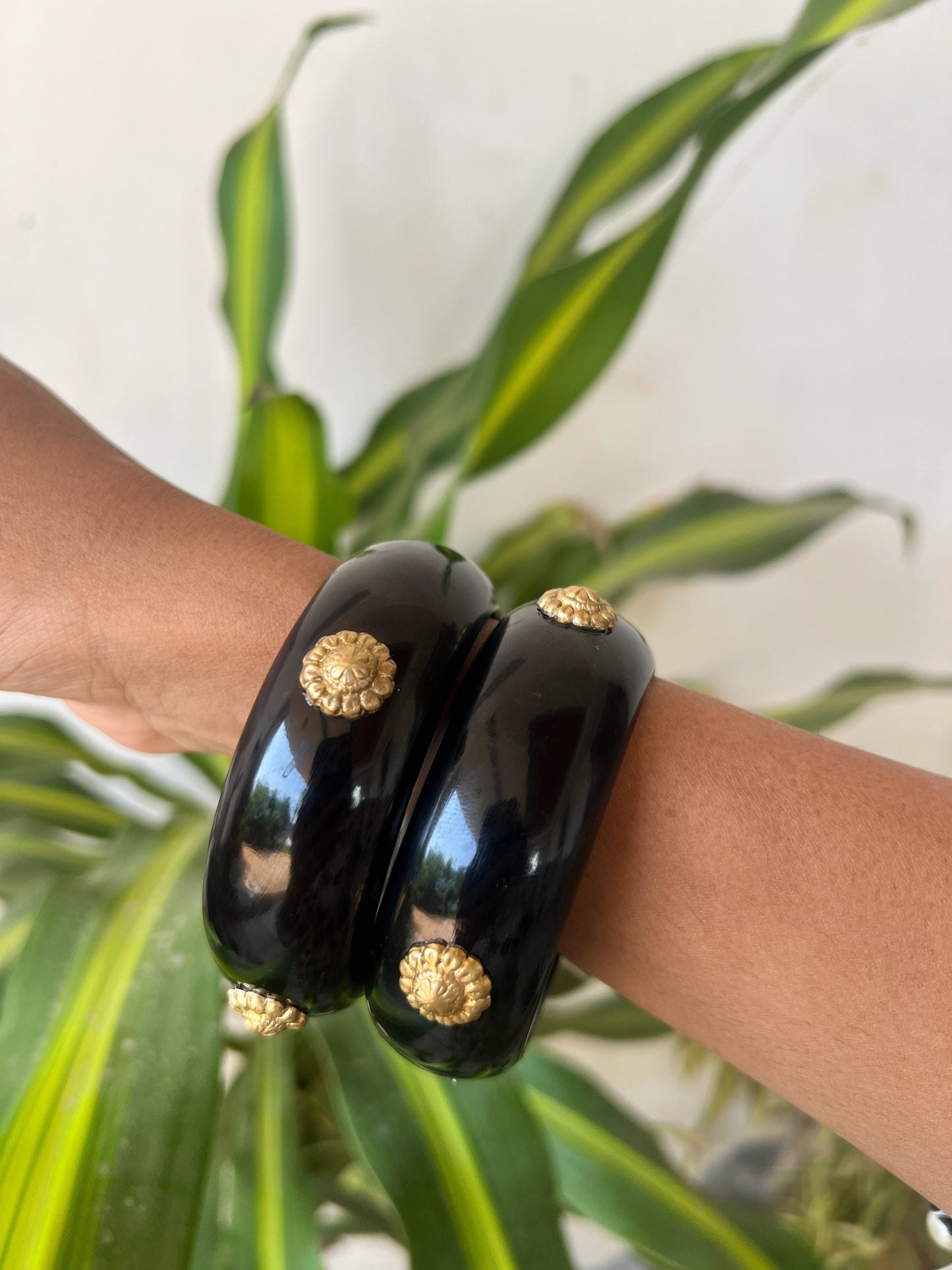 Black resin bangles with gold motifs