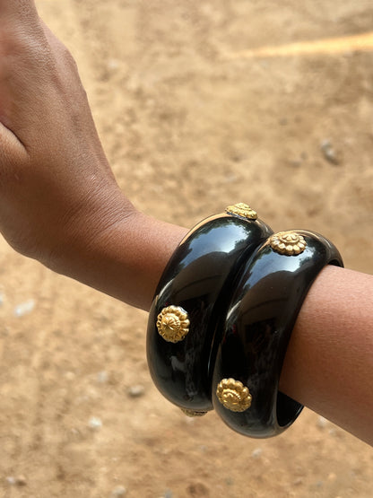 Black resin bangles with gold motifs