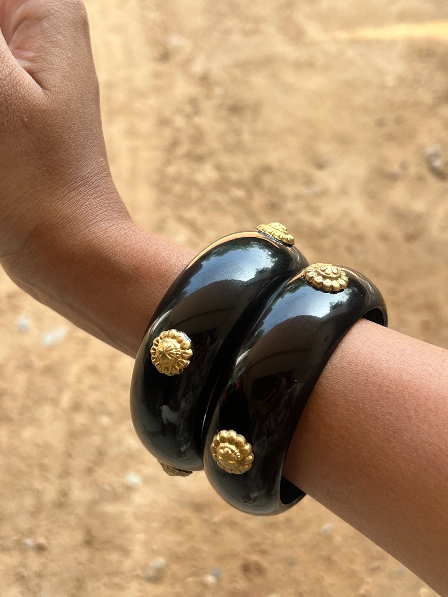 Black resin bangles with gold motifs