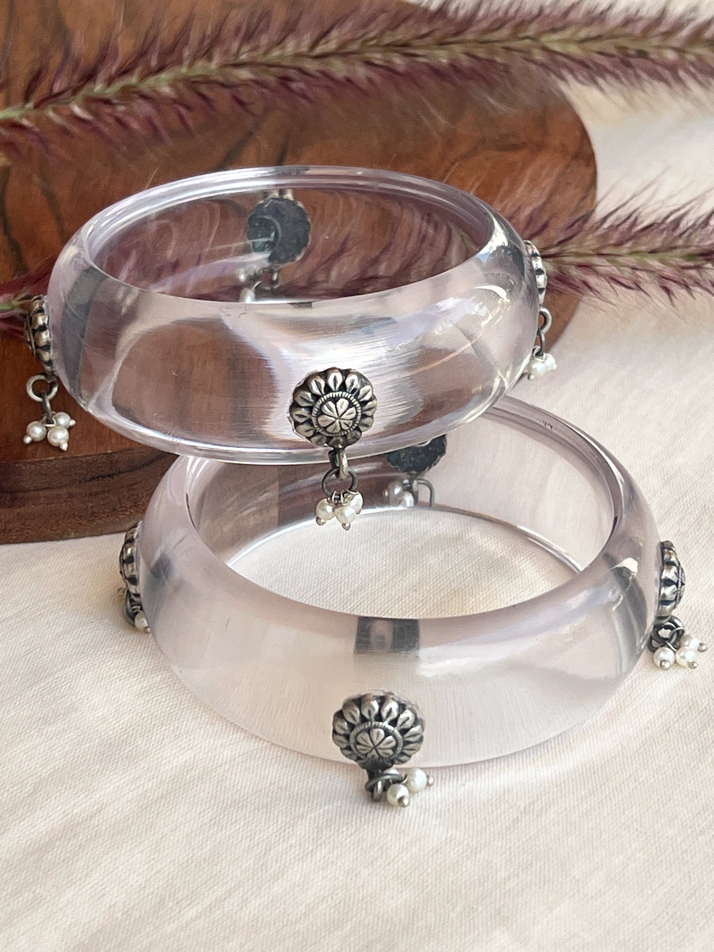 Transparent Resin bangles with silver motifs and pearl hangings